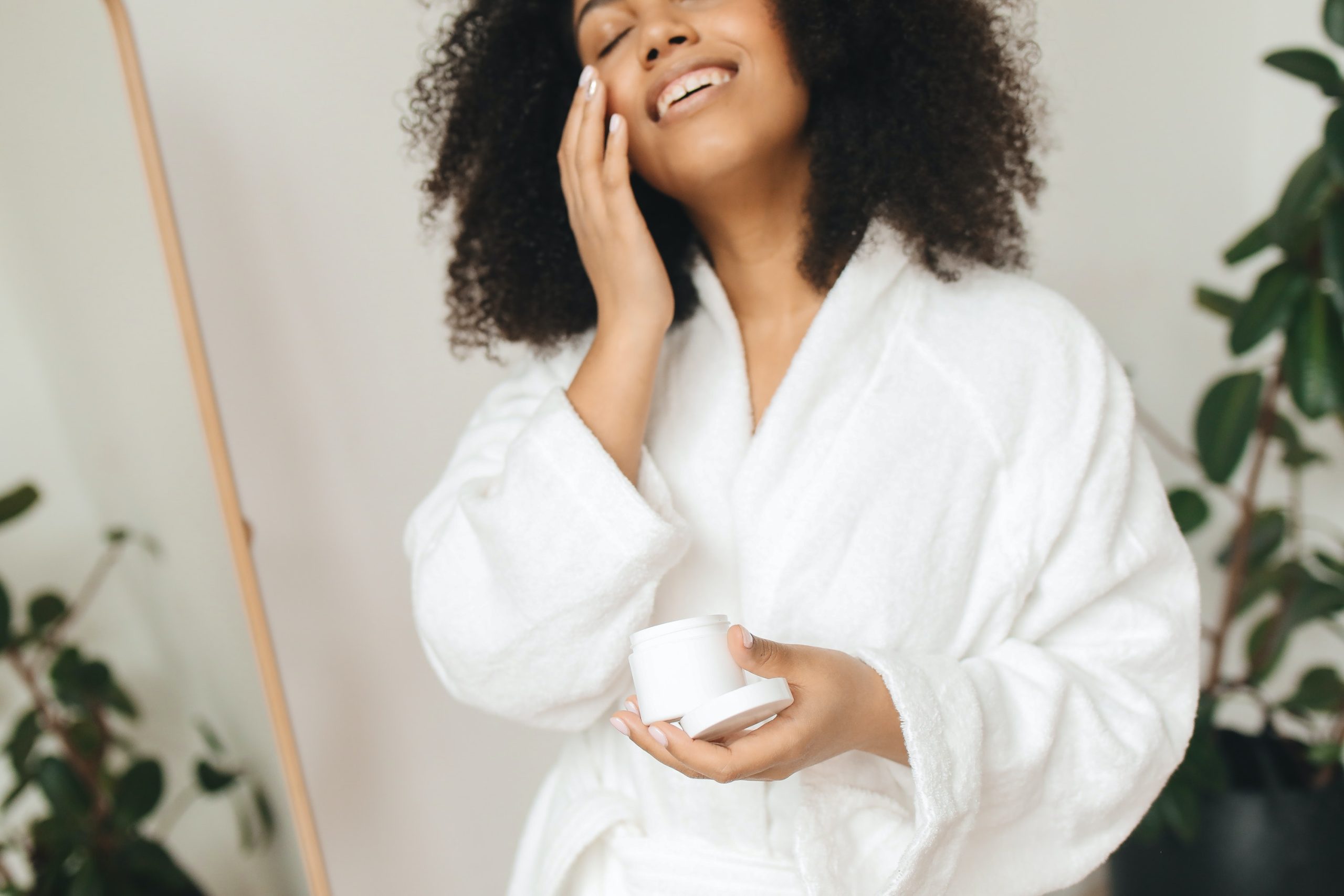 black lady applying face cream our promise to you Natural Beauty and Wellness Brand | Black African Organics